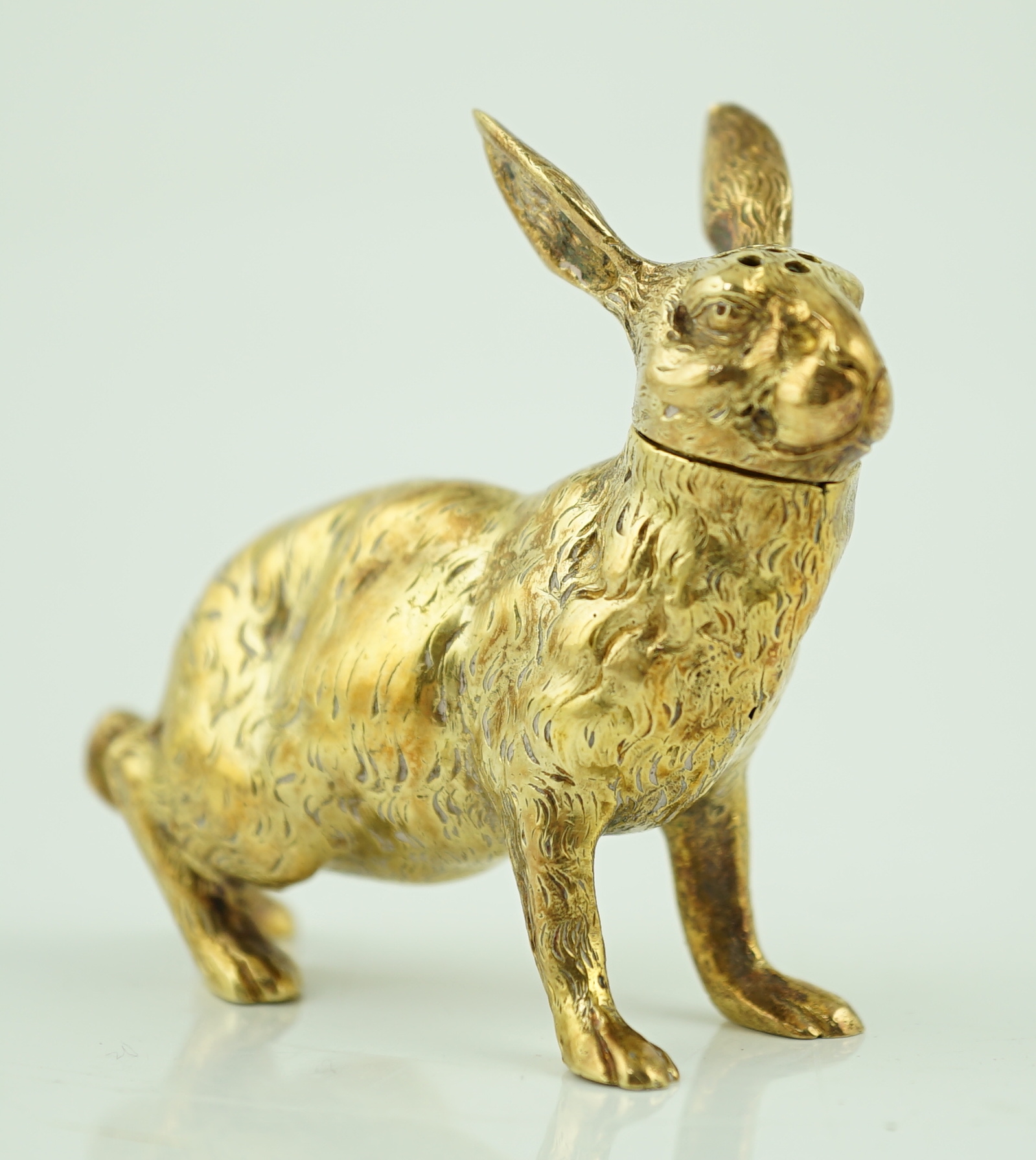 An early 20th century German novelty 800 standard silver gilt pepperette, modelled as a rabbit